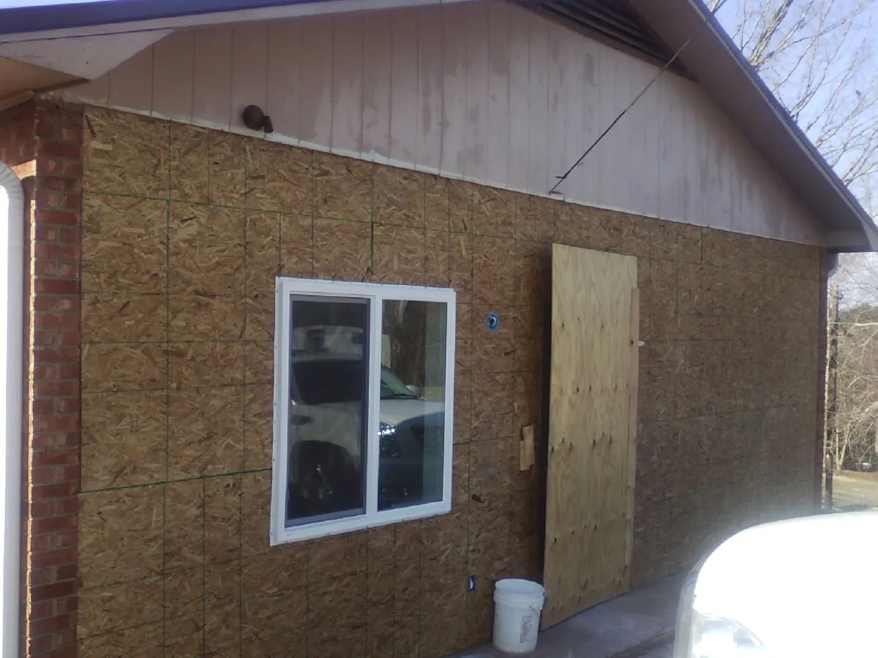 OSB sheathing on a garage addition wall before siding in Long Lake